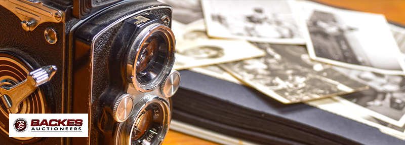 Image for Close up of vintage camera and printed photos in the background