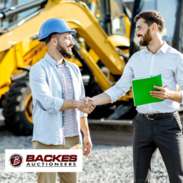 Image for Two men shaking hands outdoors in front of some construction equipment