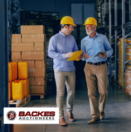 Image for Two nicely dressed man in hard hats happily discussing in warehouse