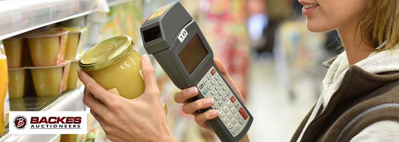 Image for Woman holding a jar with a scanning device in hand.