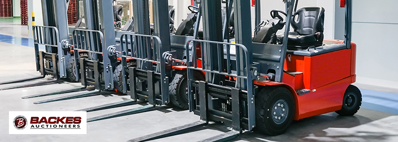 Image for four red forklifts next to each other