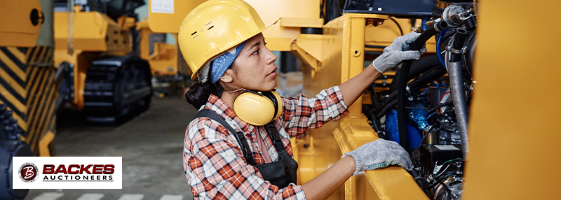 Image for Female worker inspecting machinery 