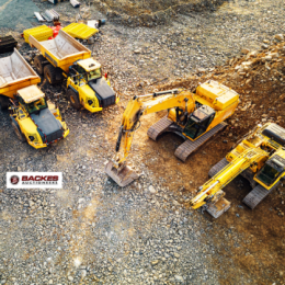 Image for Aerial view of construction machinery on jobsite including excavator and dump truck